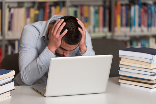 stressed student working on a computer